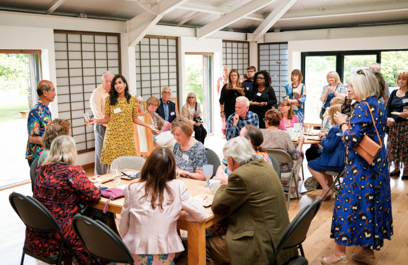 Claire addressing a packed room of members of the Friendship Project