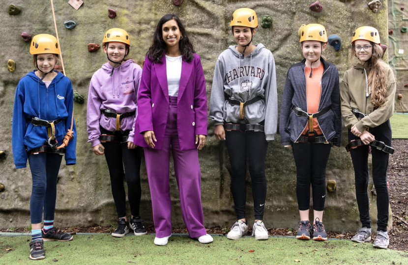 Claire standing with children on the HAF programme.