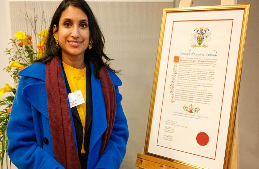 Claire stands with the Coronation Scroll. 