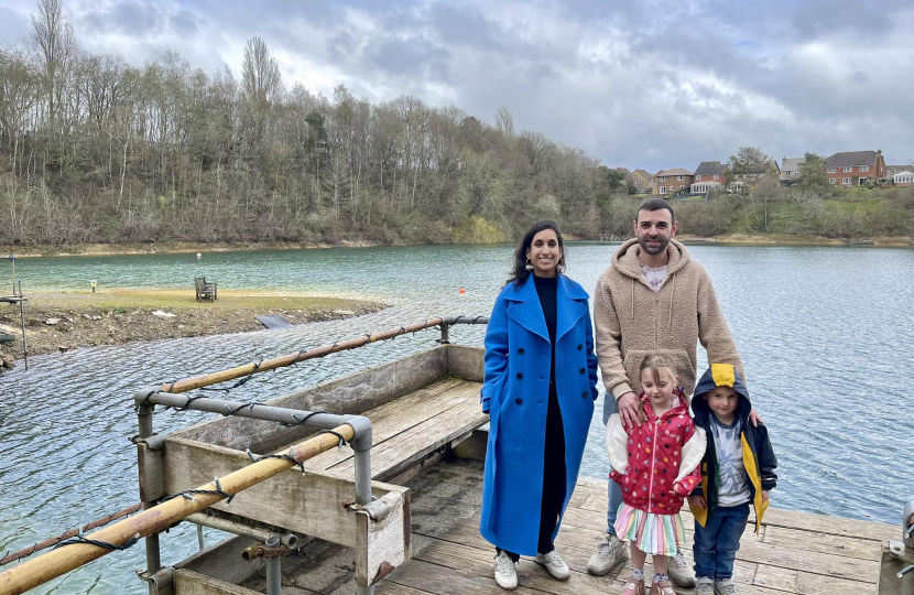 Claire standing on a jetty with Charlie and his children.