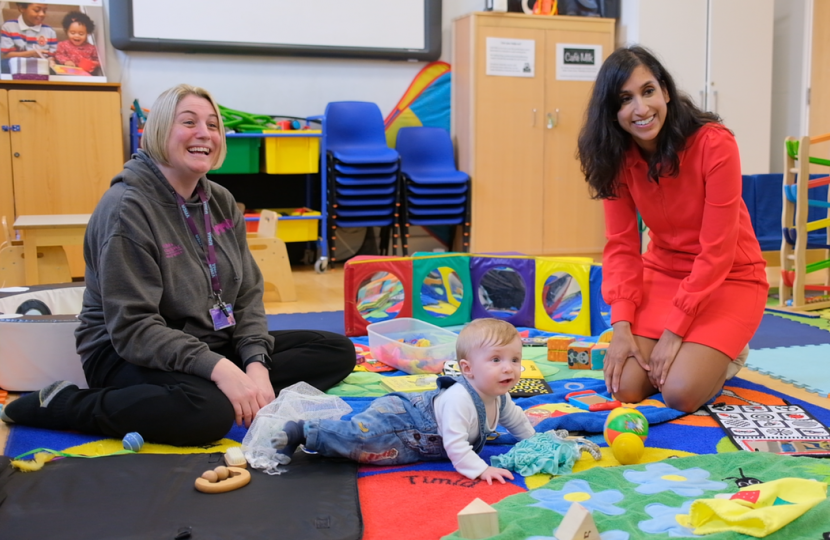 Claire playing with a baby at a pre-school.