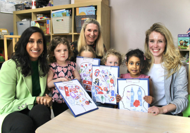 Claire with children at a nursery.