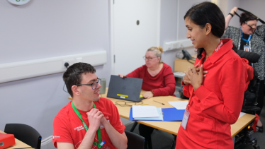 Claire chatting to a student in an Orpheus classroom